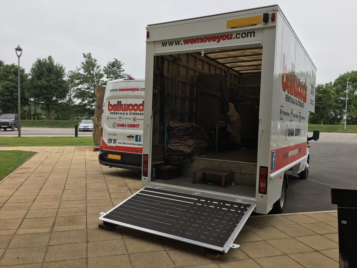 A Bellwoods removal van with its tail-lift down, ready for a long-distance piano move