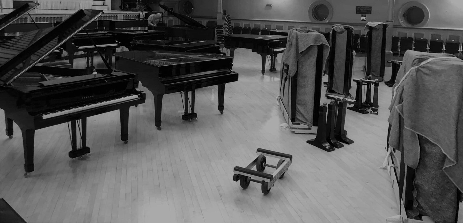 Grand pianos arranged in Huddersfield Town Hall after a Bellwoods move