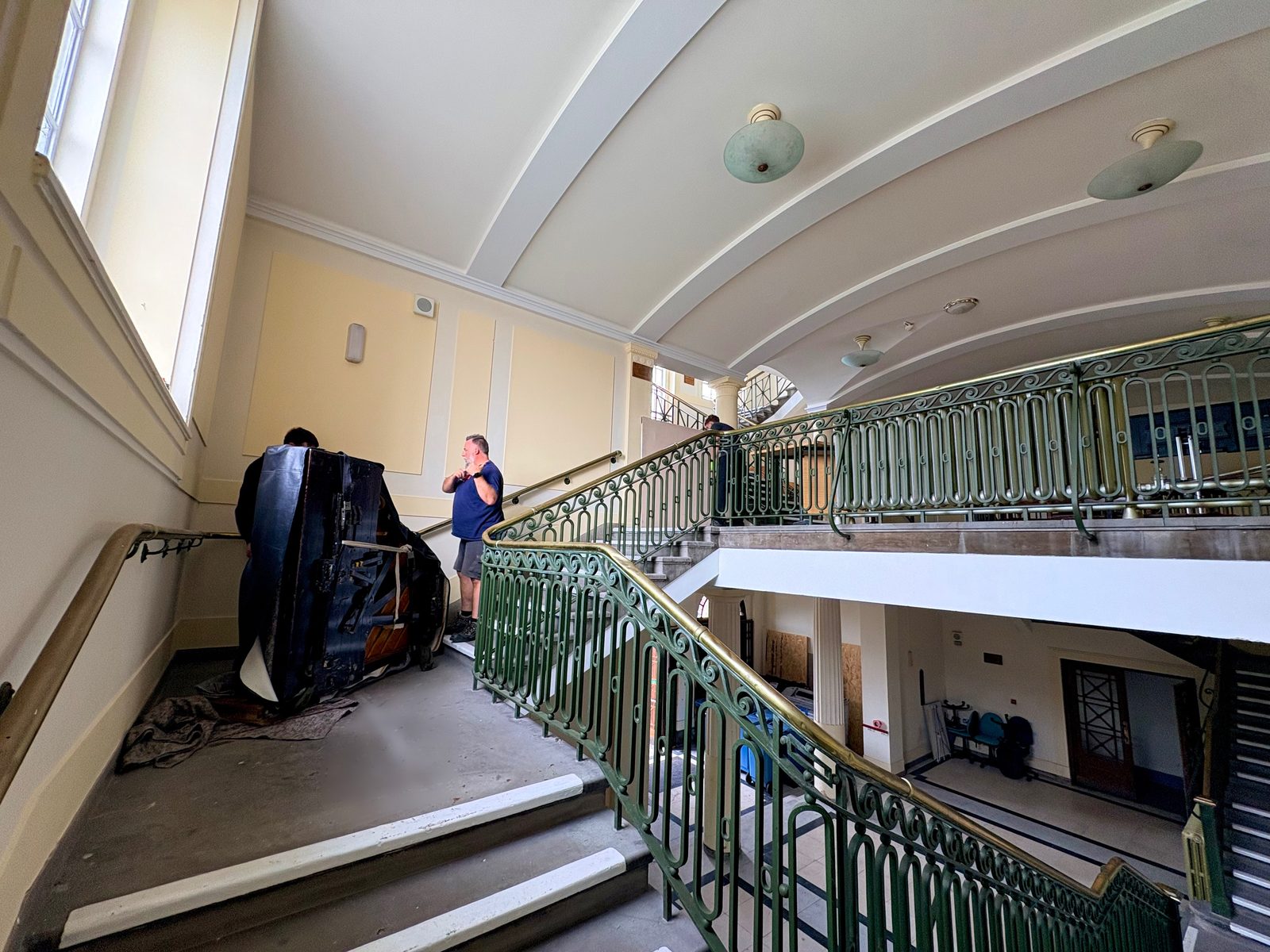 Grand piano on a piano board on an upper landing of the staircase inside Wallasey Town Hall