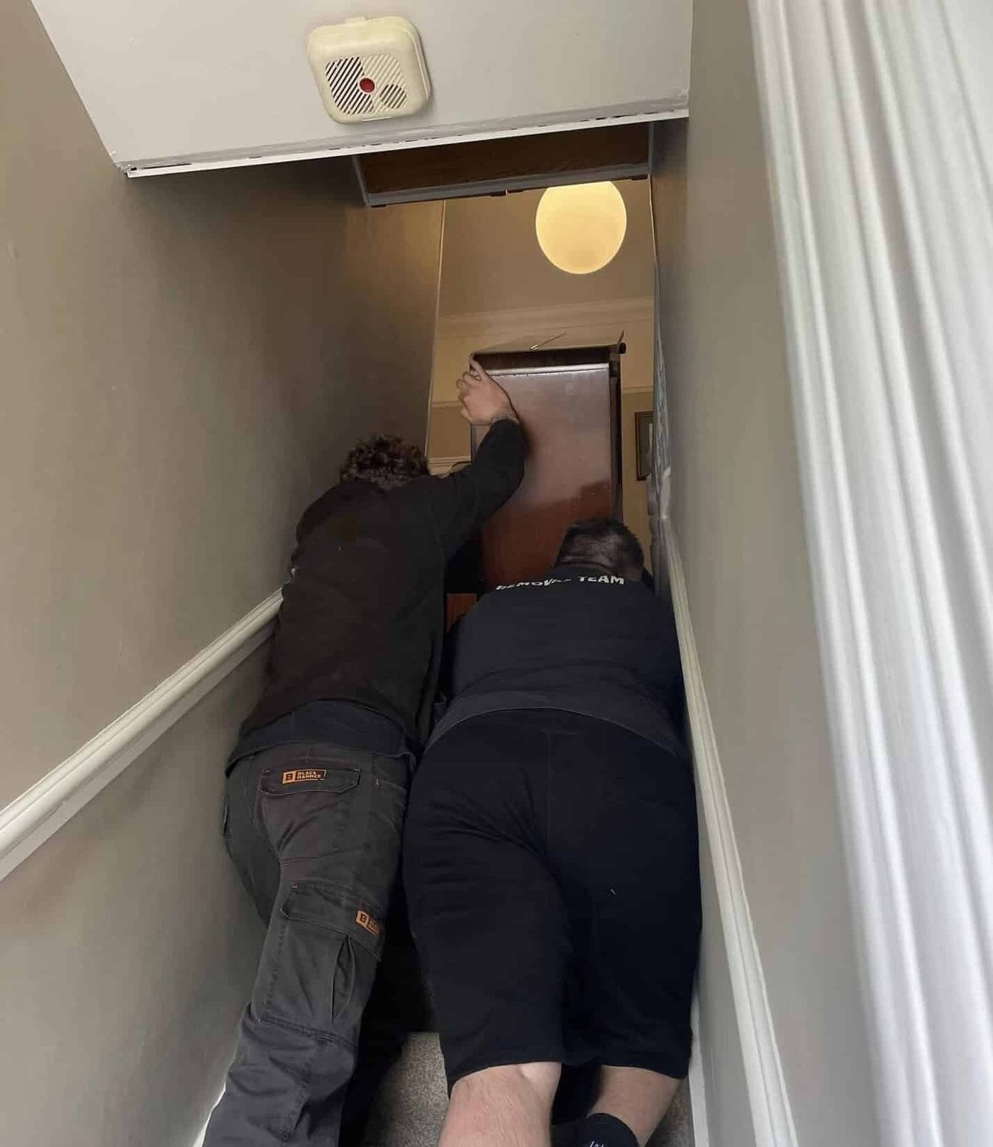 A piano being removed from upstairs for recycling