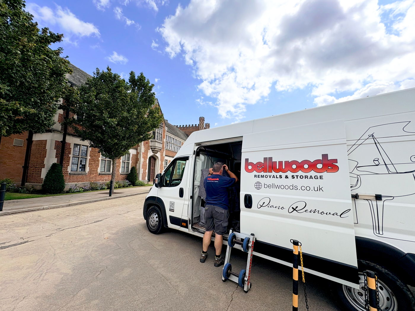 Bellwoods piano removal van with the side door open and a piano skate ready at the kerb