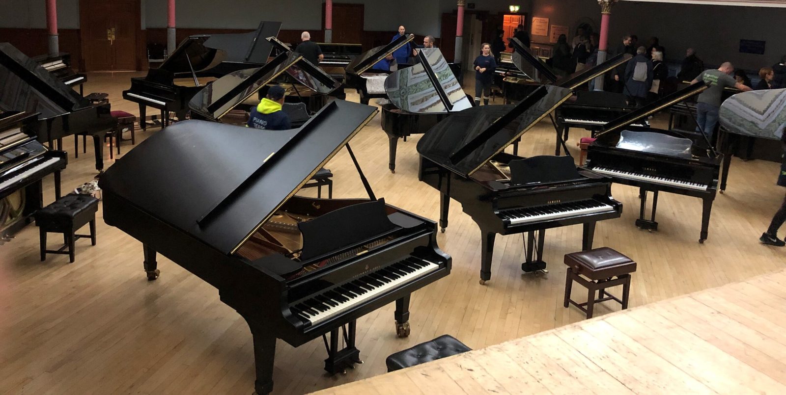A room full of grand pianos moved by Bellwoods into Huddersfield Town Hall